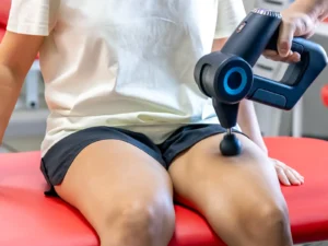 Massage gun being used on a person's leg