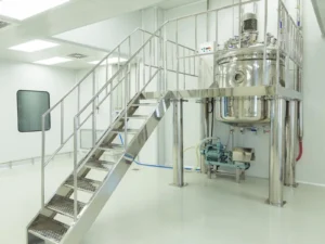 Industrial stainless steel processing tank and stairs.