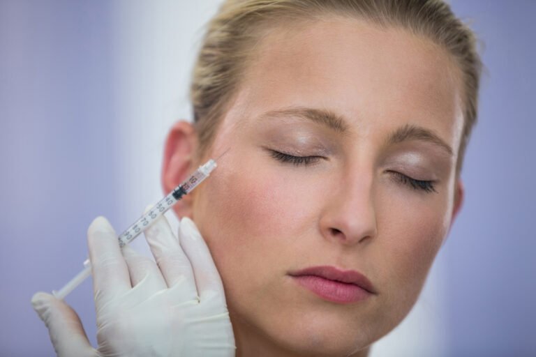 Close-up of female patient receiving a botox injection on face